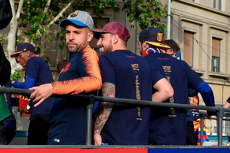 Jordi Alba, left, and his teammates during the open top bus parade celebrating Barcelona's Primera Liga title victory. Lluis Gene / AFP