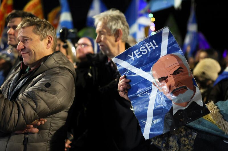 A person holds a placard depicting Scottish actor Sean Connery during a rally outside the Scottish parliament in Edinburgh on Wednesday. Reuters
