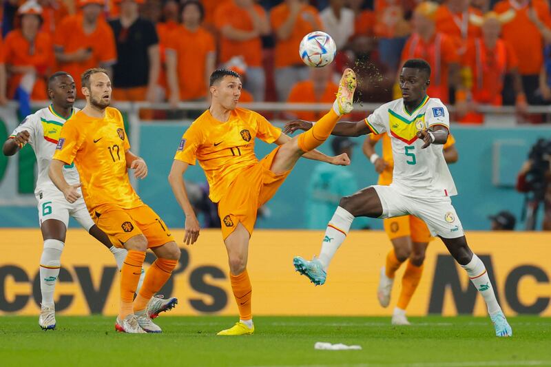 Netherlands' midfielder Steven Berghuis lifts the ball past Senegal midfielder Idrissa Gana Gueye. AFP