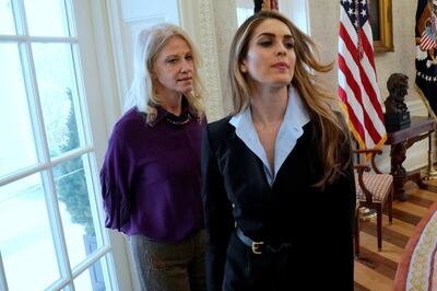 FILE PHOTO: White House Communications Director Hope Hicks departs as she and White House counselor Kellyanne Conway (L) stand on the sidelines while U.S. President Donald Trump speaks to reporters in the Oval Office at the White House in Washington, U.S., February 9, 2018.  REUTERS/Jonathan Ernst/File Photo
