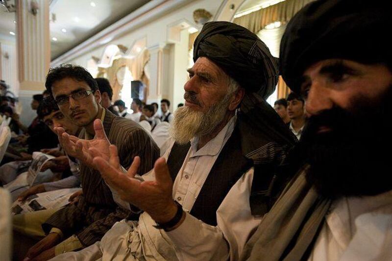 Haji Ghazi Zadran, second from right, and Gul Baheid, right, tribal elders from Paktia province, discuss the candidacy of Abdullah Abdullah.