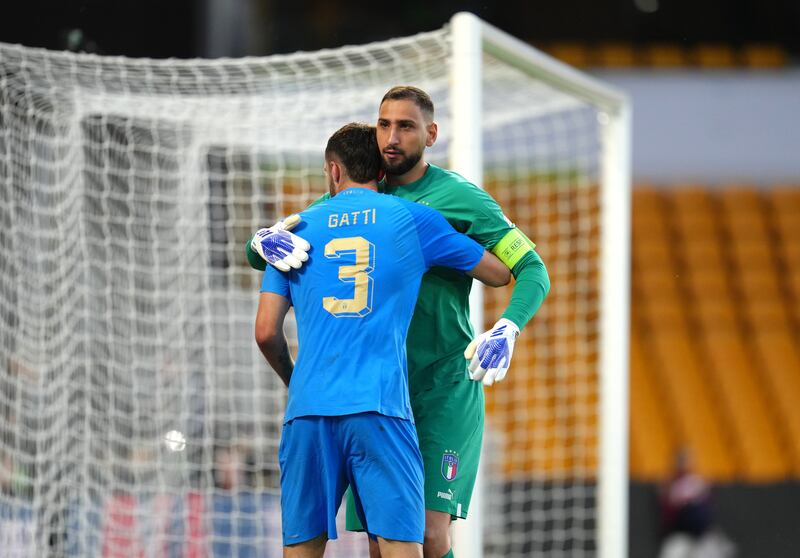 Italy's Federico Gatti hugs team-mate Gianluigi Donnarumma. PA