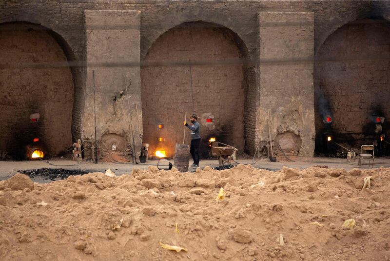 A worker fires-up brick kilns.  AFP