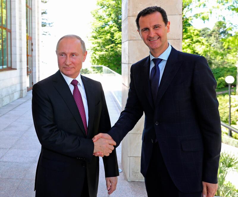 FILE - In this May 17, 2018, file photo, Russian President Vladimir Putin, left, shakes hands with Syrian President Bashar al-Assad during their meeting in the Black Sea resort of Sochi, Russia. When the presidents of Russia, Turkey and Iran meet in Tehran on Friday, Sept. 7, all eyes will be on their diplomacy averting a bloodbath in Idlib, Syria's crowded northwestern province and last opposition stronghold. The three leaders whose nations are all under U.S. sanctions have an interest in working together, but Idlib is complicated and they have little common ground. (Mikhail Klimentyev, Sputnik, Kremlin Pool Photo via AP, File)
