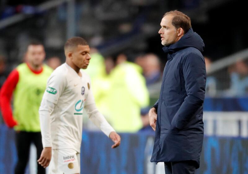 PSG manager Thomas Tuchel looks on as Kylian Mbappe walks past him after being sent off. Charles Platiau / Reuters