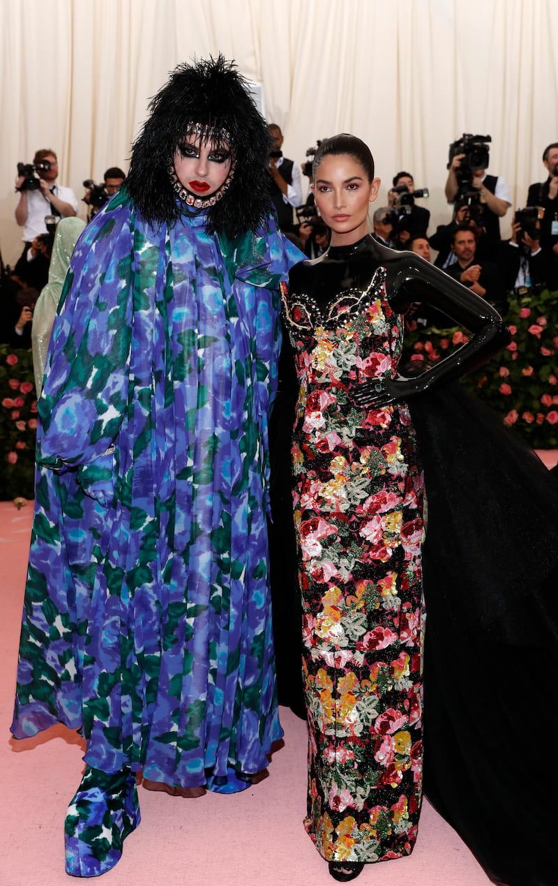 Fashion designer Richard Quinn looked astonishing in full florals (including platform boots) and jeweled chin strap, while model Lily Aldridge looked elegant but predictable. Reuters