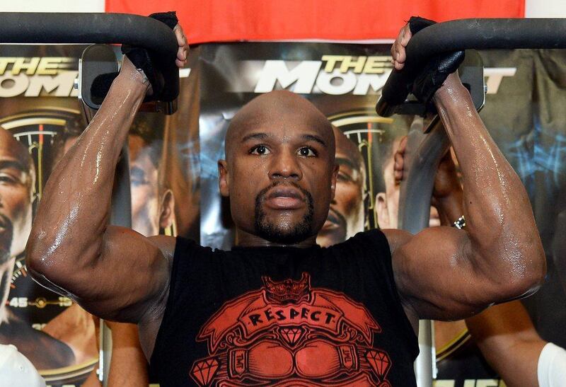 Floyd Mayweather does pull ups as he trains in front of media during a Tuesday workout session at the Mayweather Boxing Club in Las Vegas. Ethan Miller / Getty Images / AFP / April 22, 2014