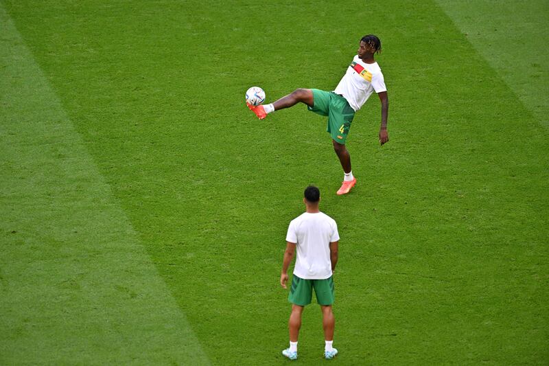 Cameroon defender Christopher Wooh traps the ball during the warm up for the Group G match against Switzerland. AFP