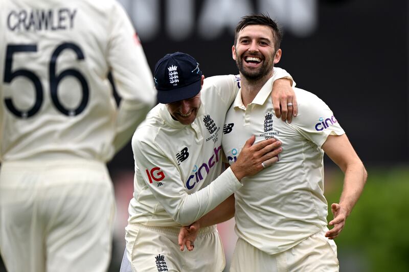 England's Mark Wood, right, celebrates with Joe Root after claiming the wicket of Steve Smith. Getty