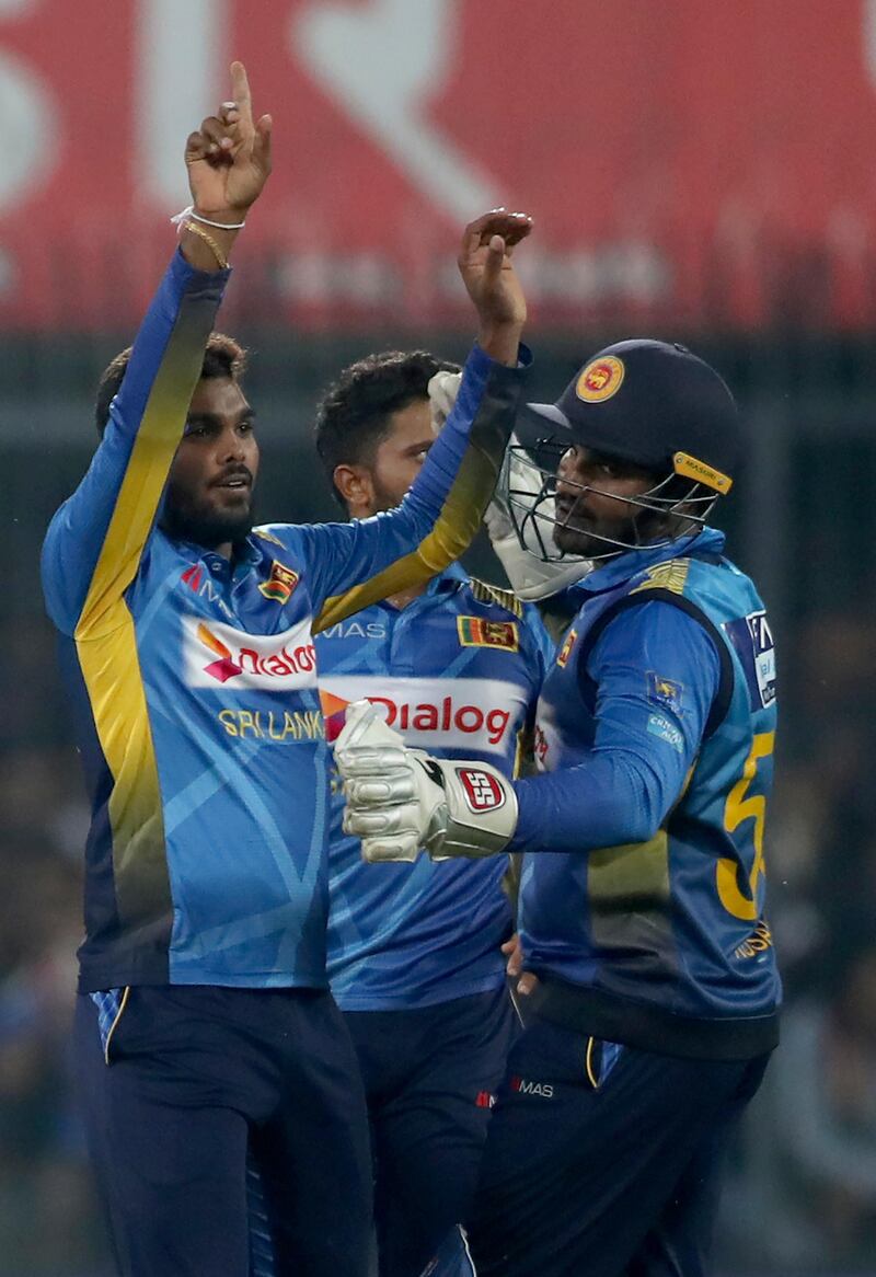 Sri Lanka's Wanindu Hasaranga, left, celebrates with teammates the dismissal of India batsman KL Rahul. AP