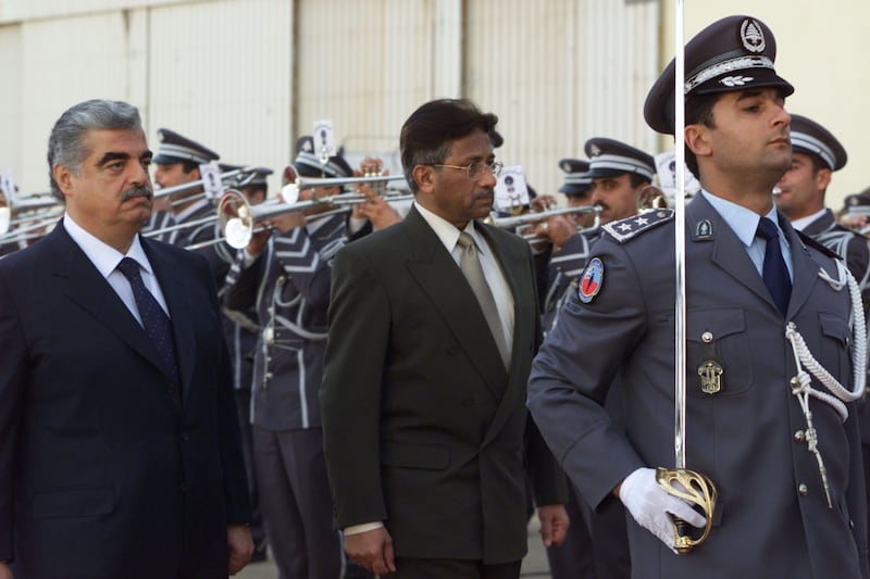 Lebanese Prime Minister Rafik Al Hariri reviews the honour guard with Mr Musharraf upon his arrival at Beirut airport on January 9, 2001. Reuters