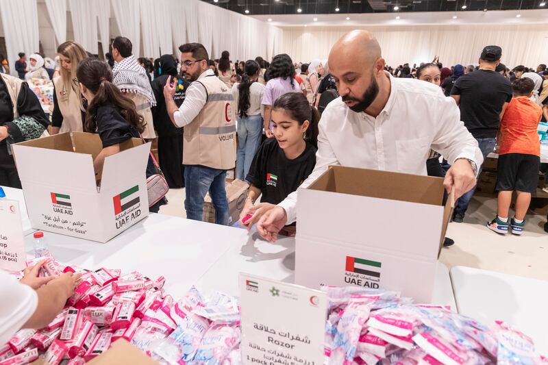 Volunteers pack aid for Palestine at an event Dubai last week. Antonie Robertson / The National
