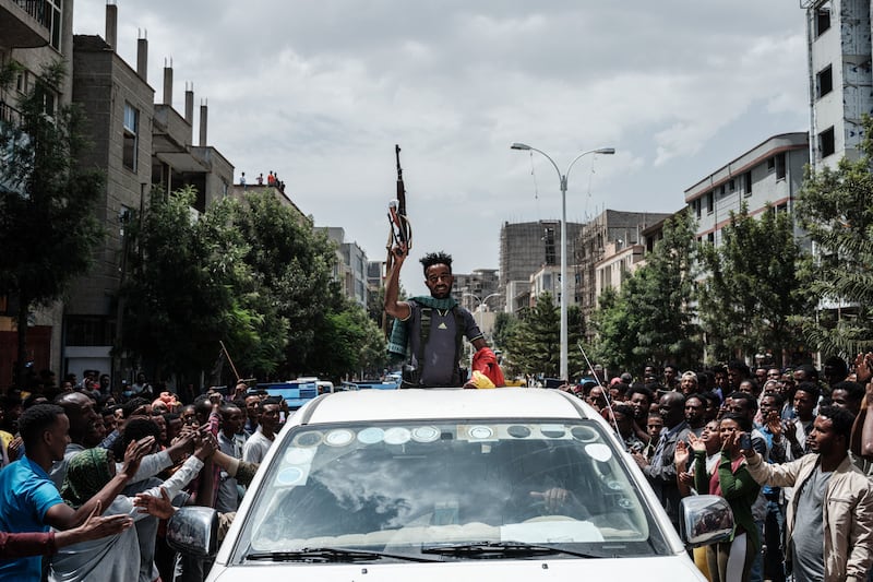 A soldier parades by a car in Mekelle.