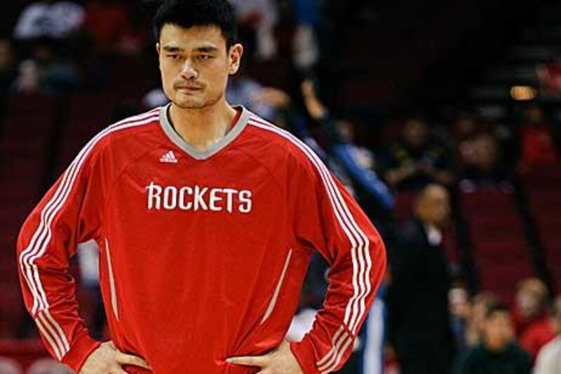 Yao Ming looks forlorn as he waits for medical attention.