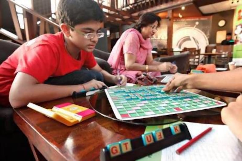 Sanchit Kapoor, 12, will be competing in the 7th annual World Youth Scrabble Championships with two other UAE teammates in Birmingham, UK from December 7th-9th. Kapoor is seen here practicing with his teammates at the Tea Junction Cafe in Oud Metha. Jeff Topping / The National