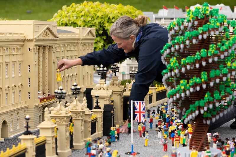 Model maker Paula Young places a model of Queen Elizabeth during a jubilee photo call at Legoland Windsor in Windsor, England. The resort's platinum jubilee display includes approximately 18,000 bricks and took around 280 hours to build. Getty Images
