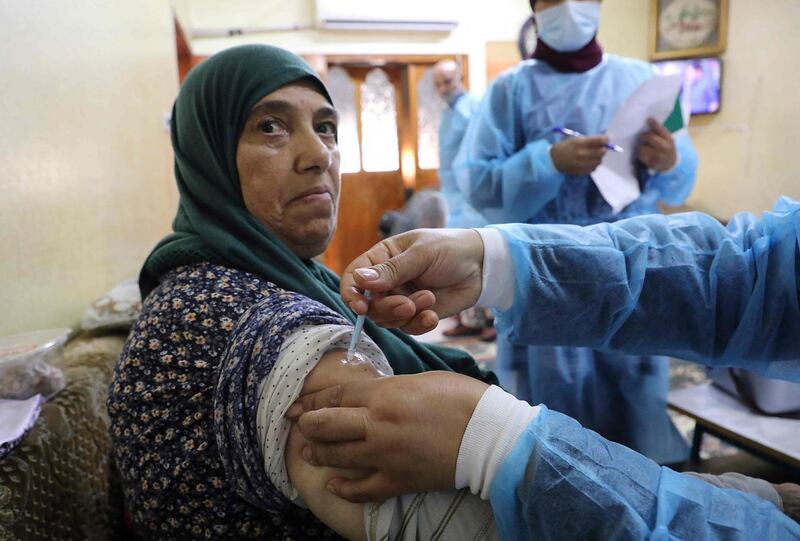 A Palestinian ministry of health nurse administers a dose of the Comirnaty Pfizer-BioNTech Covid-19 coronavirus vaccine in the village of Dura near Hebron in the occupied West Bank. AFP