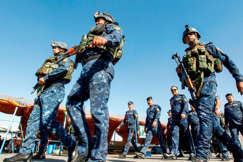 Policemen secure the area on the outskirts of Baghdad. AFP