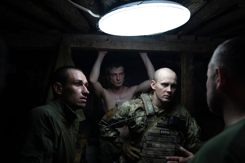 Ukrainian servicemen in a shelter at the frontline near Kharkiv. AP
