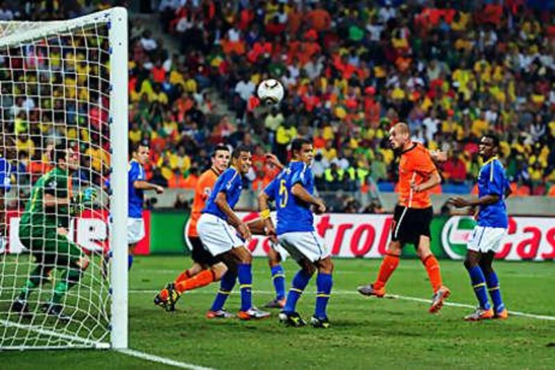 Wesley Sneijder, second right, heads home the Dutch winner on 68 minutes to dump Brazil out of the World Cup.