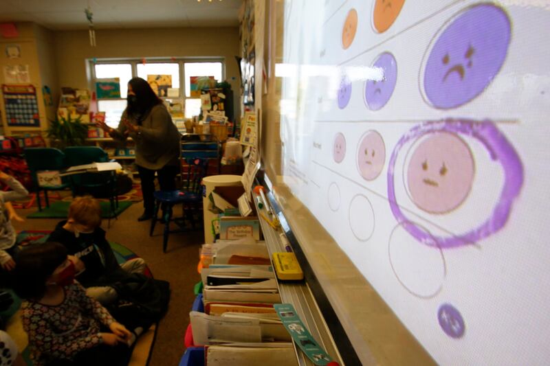 Second-grade teacher Melissa Shugg teaches a lesson at Paw Paw Elementary School about thoughts, feelings and actions on December 2, 2021, in a school in, Michigan, US. Shugg is one of many teachers at the school who've been trained to teach a social-emotional curriculum created at the University of Michigan called TRAILS.  Research suggests TRAILS lessons for at-risk kids can reduce depression and improve coping skills. AP