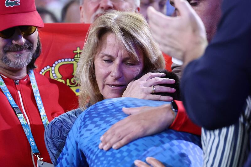 Novak Djokovic embraces his mother Dijana as he celebrates victory. AFP