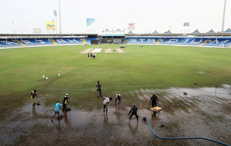 SHARJAH, UNITED ARAB EMIRATES , Dec 11– 2019 :- Ground staff clearing  the rain water from the cricket ground at the Sharjah Cricket Stadium in Sharjah. World Cup League 2 match between UAE vs Scotland abandoned due to wet ground. ( Pawan Singh / The National )  For News/Sports/Instagram/Online. Story by Paul