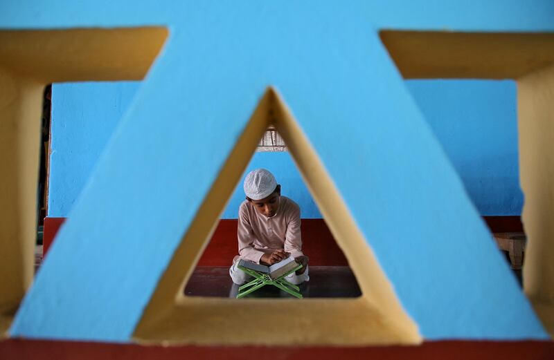A Muslim boy reads the Quran inside a mosque on the first day of Ramadan on the outskirts of Agartala, India. Reuters