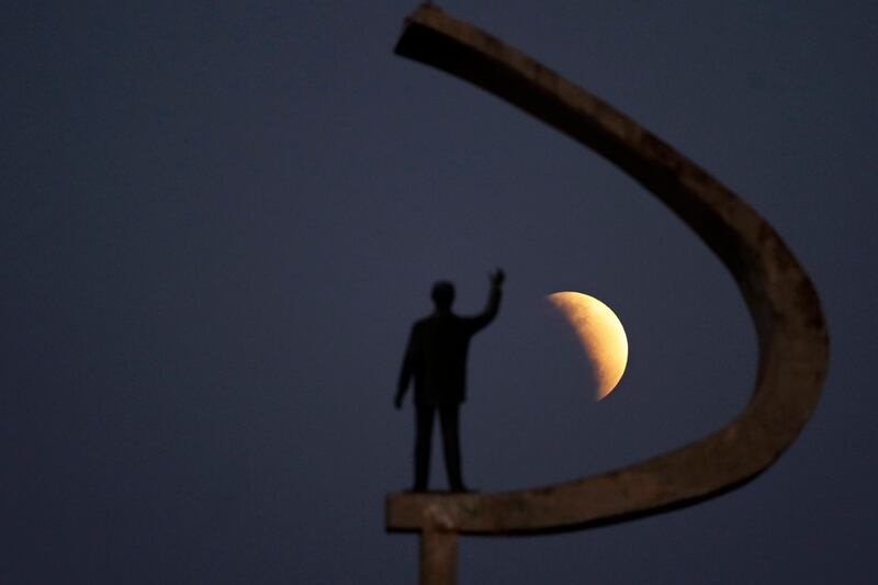 A statue of Brazil's former President Juscelino Kubitschek, founder of Brasilia, stands during a partial lunar eclipse in the skies over Brasilia, Brazil. AP Photo/Eraldo Peres