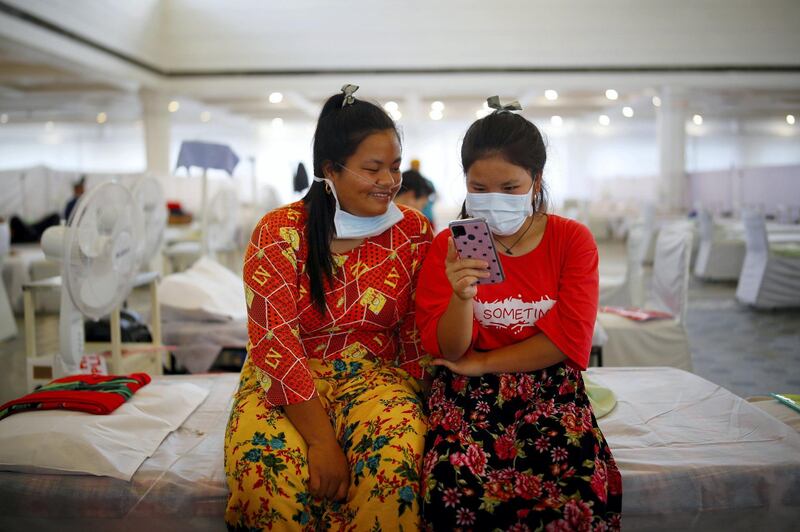 Indian Jewish girls, members of the Bnei Menashe, or the Children of Menashe, one of the "lost tribes of Israel" from the India's northeastern state of Manipur, suffering from the coronavirus disease (COVID-19), look at a mobile phone at a COVID-19 care facility, inside a Gurudwara or a Sikh Temple, in New Delhi, India, June 2, 2021. REUTERS/Adnan Abidi  REFILE - CORRECTING WORDING