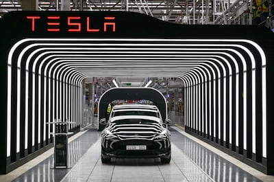 FILE - Model Y electric vehicles stand on a conveyor belt at the opening of the Tesla factory in Berlin Brandenburg in Gruenheide, Germany, Tuesday, March 22, 2022. AP