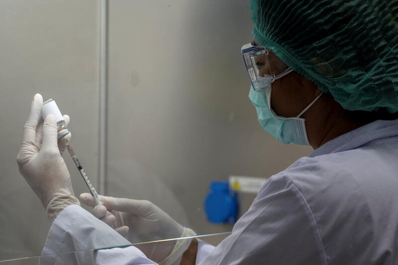 A researcher works inside a laboratory at the National Primate Research Center of Chulalongkorn University during the development of an mRNA type vaccine candidate for the coronavirus disease (COVID-19) in Saraburi province, Thailand, June 22, 2020. REUTERS/Athit Perawongmetha