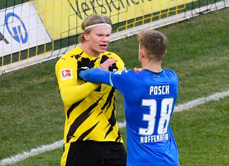 Hoffenheim's Stefan Posch clashes with Borussia Dortmund's Erling Braut Haaland. Reuters