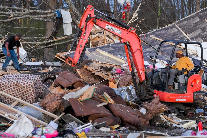 Residents look through a destroyed home in Amory. EPA