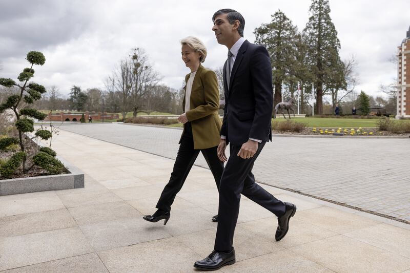 Mr Sunak and Ms von der Leyen make their way into the hotel. PA