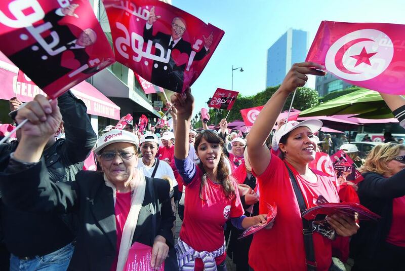 Supporters of Tunisian presidential candidate Beji Caid Essebsi shout slogans and wave flags during an election campaign in the capital, Tunis, on November 21. Fadel Senna / AFP Photo