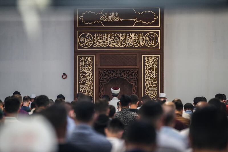 epa08576317 Muslims wearing face mask gather and pray in a Turkish mosque to pray and mark the Muslim religious holiday of Eid aL-Adha, at the northern suburbs of Paris, France , 31 July 2020. Eid al-Adha is the holiest of the two Muslims holidays celebrated each year, it marks the yearly Muslim pilgrimage (Hajj) to visit Mecca, the holiest place in Islam. Muslims slaughter a sacrificial animal and split the meat into three parts, one for the family, one for friends and relatives, and one for the poor and needy.  EPA/Mohammed Badra