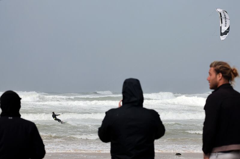 A kite-surfer rides the storm in Netanya. AFP