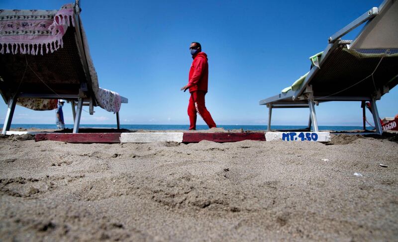 A lifeguard checks the distance between the sun beds on the beach of Fregene near Rome. AFP