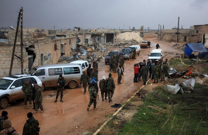 Syrian soldiers re-group after taking control of the village of Ratian, north of the embattled city of Aleppo, from rebel fighters on February 6, 2016. George Ourfalian/AFP







