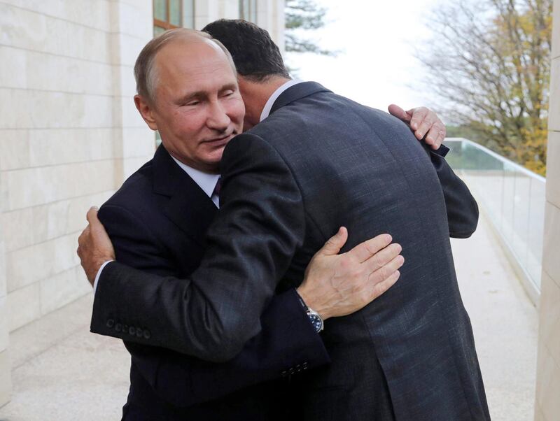 In this Monday, Nov. 20, 2017, photo, Russian President Vladimir Putin, left, embraces Syrian President Bashar Assad in the Bocharov Ruchei residence in the Black Sea resort of Sochi, Russia. Putin has met with Assad ahead of a summit between Russia, Turkey and Iran and a new round of Syria peace talks in Geneva, Russian and Syrian state media reported Tuesday. (Mikhail Klimentyev, Kremlin Pool Photo via AP)