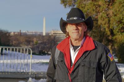 A supporter of former president Donald Trump poses in front of the National Mall on January 6, 2022. Willy Lowry / The National