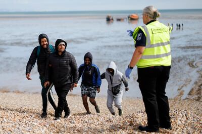 Migrants rescued from a boat crossing the English Channel land in Kent in August. EPA 