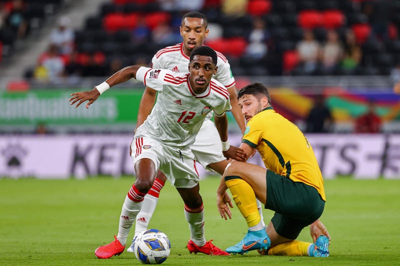 UAE's defender Khalifa Al Hammadi dribbles past Australia's Alex Wilkinson at the Ahmad bin Ali stadium on Tuesday. AFP