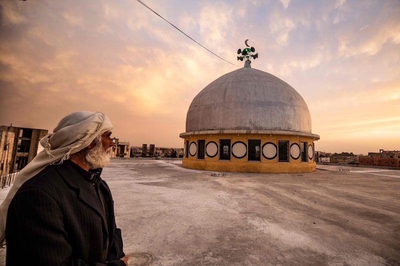 A man stares at the dome of a mosque, in Syria's northern city of Raqa. AFP