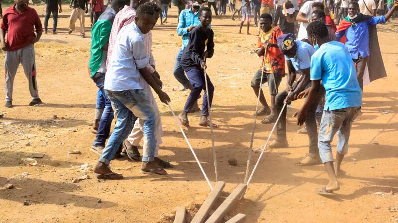 Protesters try to block the road during a rally against military rule in Khartoum. Reuters