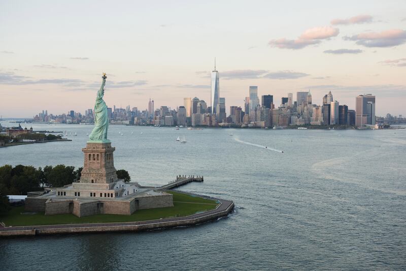 As Liberty Island draws closer, the full impact of the 305-foot Statue of Liberty makes itself known. Below, Ellis Island Immigration Museum. Jamie Grill / Tetra Images / Corbis; John Moore / Getty Images / AFP 