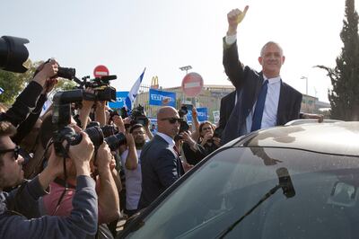 Blue and White party leader Benny Gantz gives thumb up to his supporters after casting vote during Israel's general elections in Rosh Haayin, Israel, Tuesday, April 9, 2019. (AP Photo/Sebastian Scheiner)