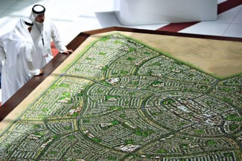 ABU DHABI - 17APRI 2011 - Visitors looks at a model of Musanada-South of Shamkha project by Abu Dhabi Urban Planning on the opening day of the Cityscape yesterday at Abu Dhabi National Exhibition Centre. Ravindranath K / The National