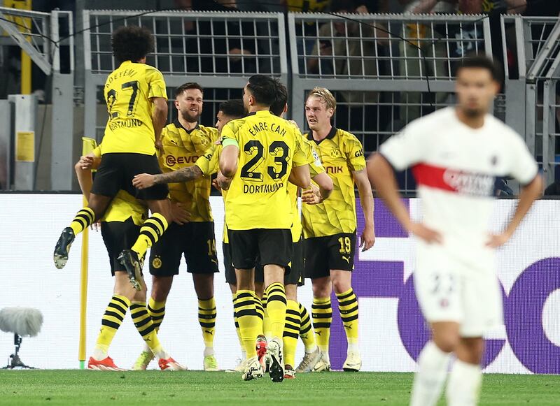 Dortmund players celebrate with Niclas Fullkrug after his opening goal against PSG.